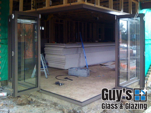When fully open our bifold doors allow continuous flow between inside and outdoor living. The view from outside looking in with doors open.