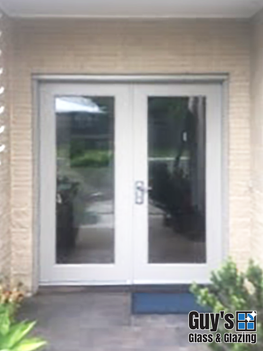 Double doors before Colonial style security doors installed