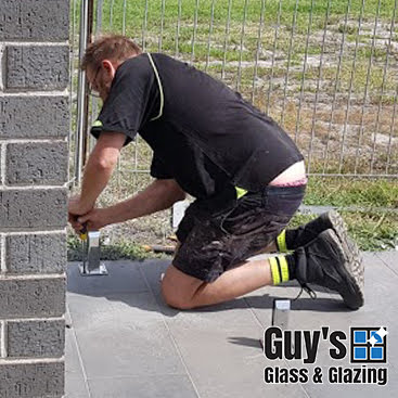 Screwing down the footings for glass panels for glass pool fencing in Traralgon 2018
